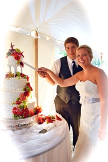 A newlywed couple enjoying their wedding cake.